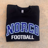 Black sweatshirt with 'NORCO FOOTBALL' text on a beige surface