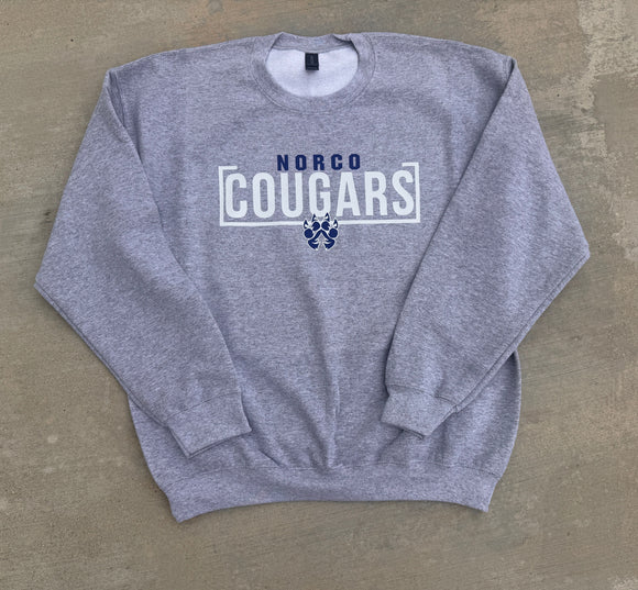 Gray sweatshirt with 'NORCO COUGARS' text and paw print on a beige background